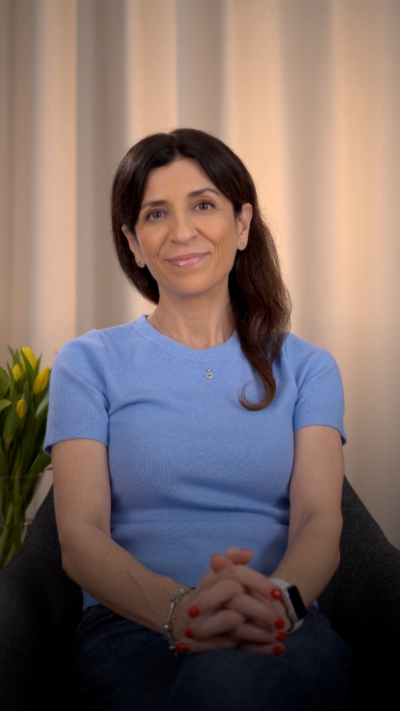 Portrait of a female dietitian in a blue shirt smiling